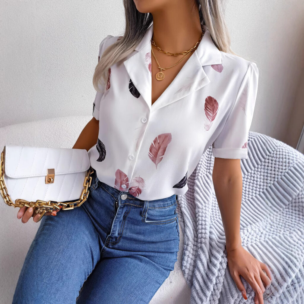 Woman in leaf shirt holding a purse.