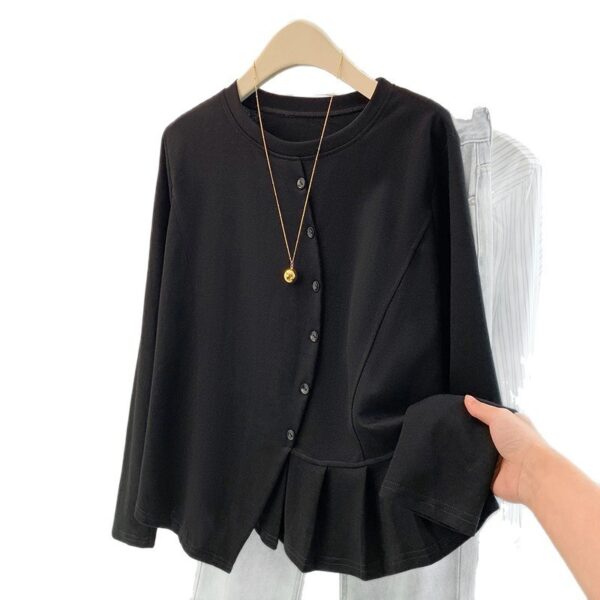 Black blouse with necklace on hanger.