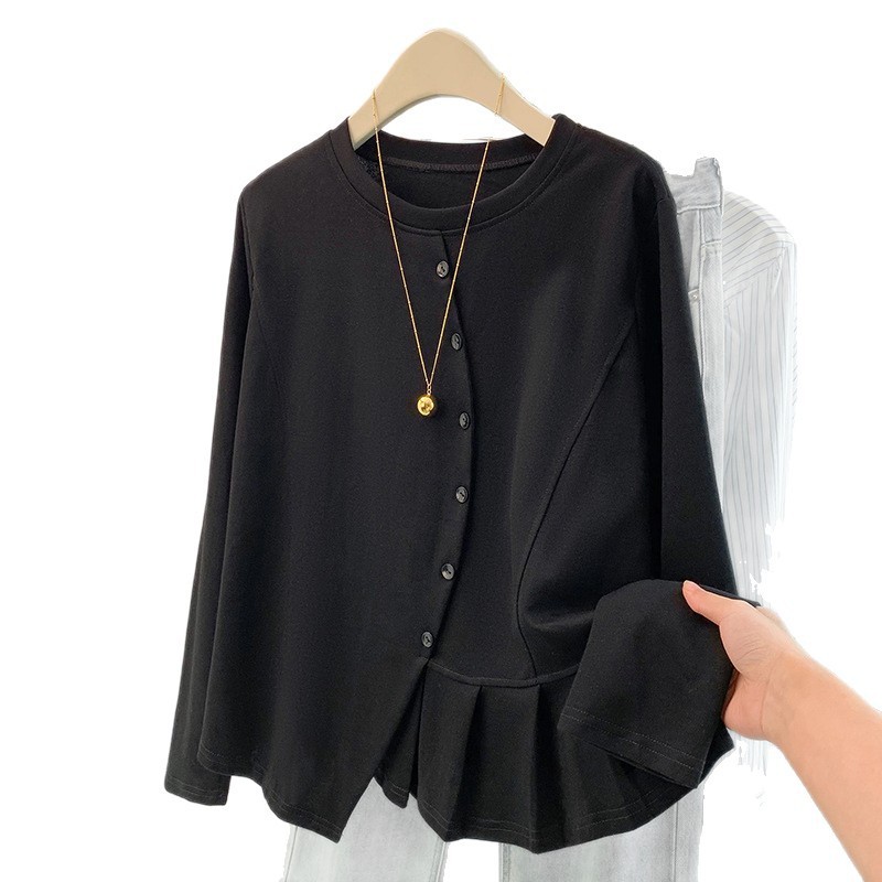 Black blouse with necklace on hanger.