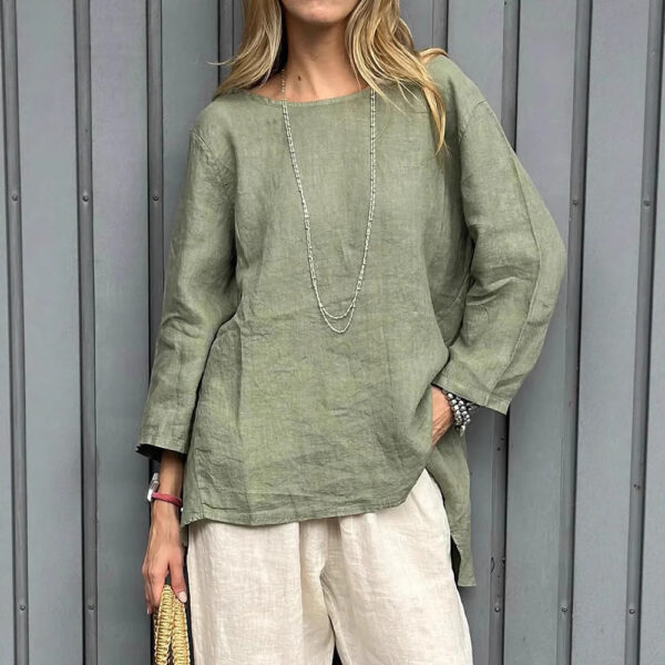 Woman in green top and beige pants.