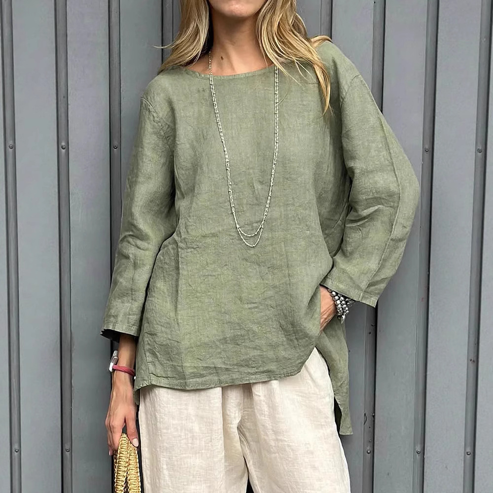 Woman in green top and white pants.