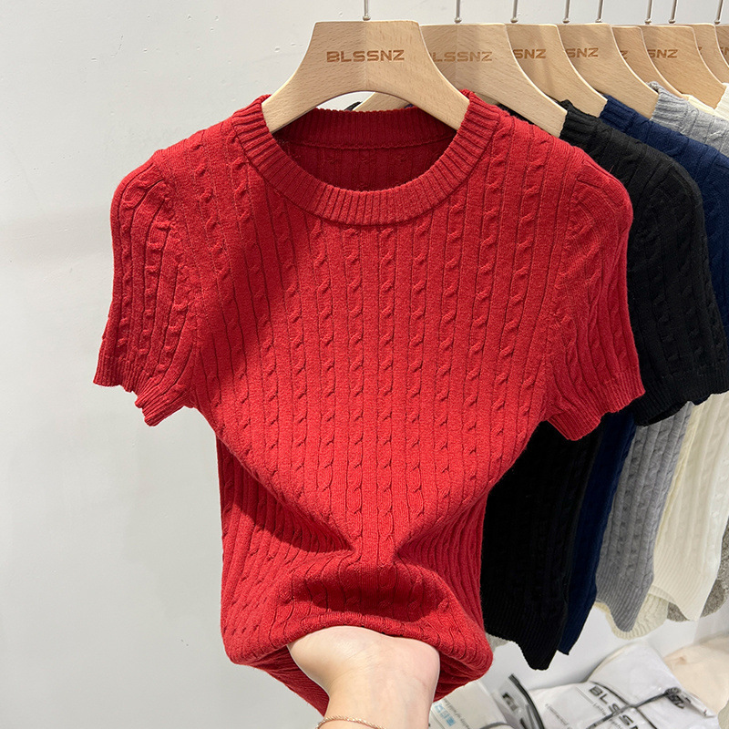 Red knit sweater on a wooden hanger.