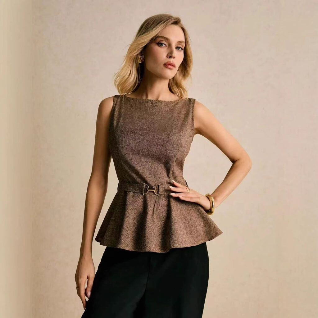Woman modeling brown top and black pants.