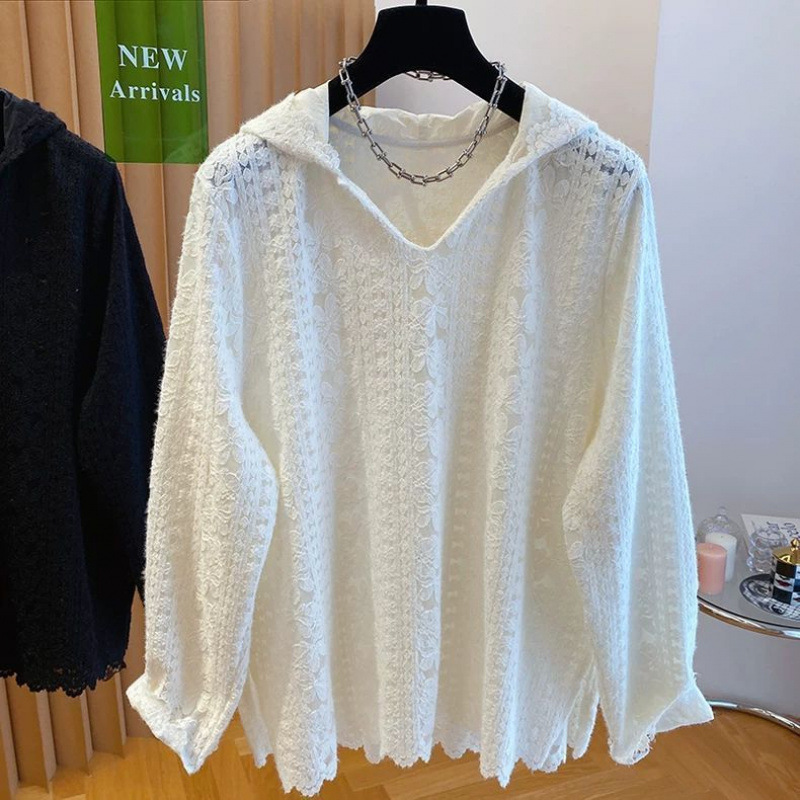 White and black lace tops on hangers.