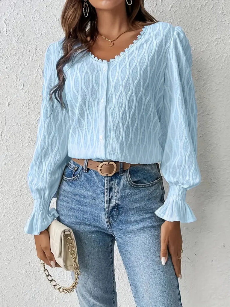 Woman in blue blouse and jeans.