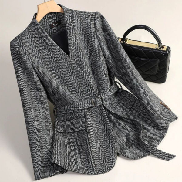 Gray herringbone blazer with black handbag.