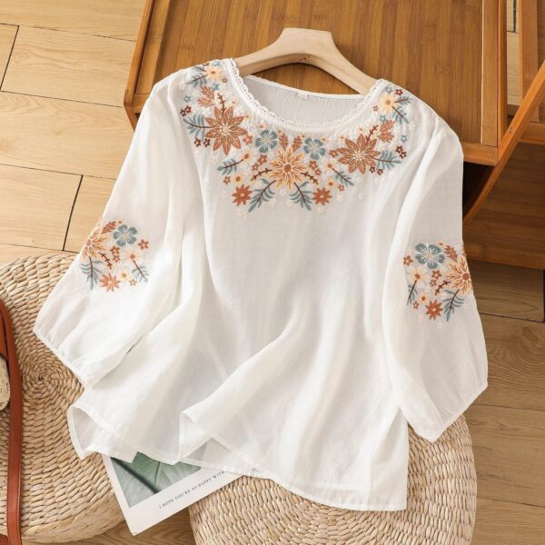 White blouse with floral embroidery design.