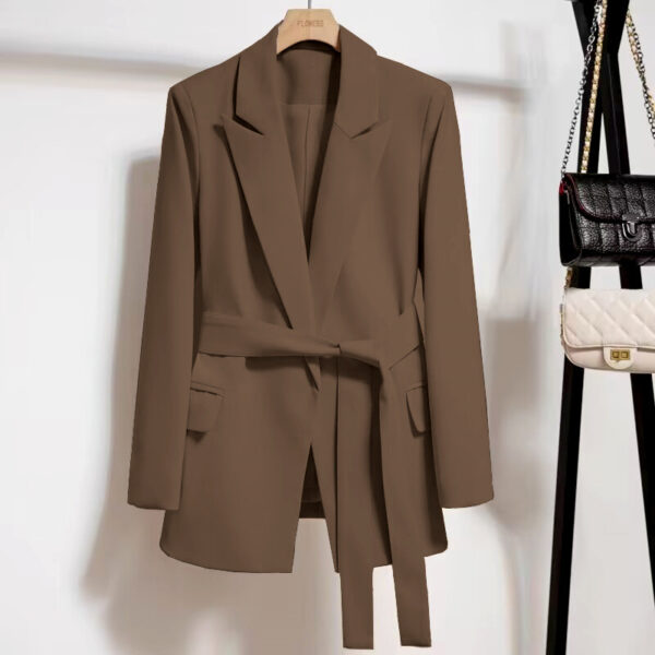 Brown blazer hanging on a hanger.