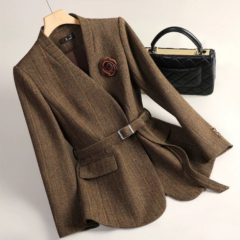 Brown blazer with belt and handbag.