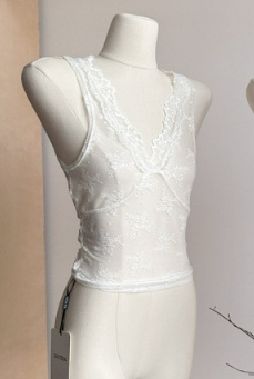 White lace sleeveless top on mannequin.