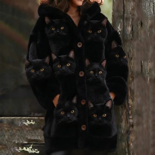 Woman wearing coat with multiple cat faces.