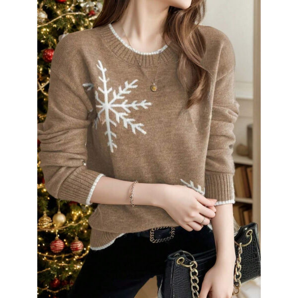 Woman in snowflake sweater near Christmas tree.