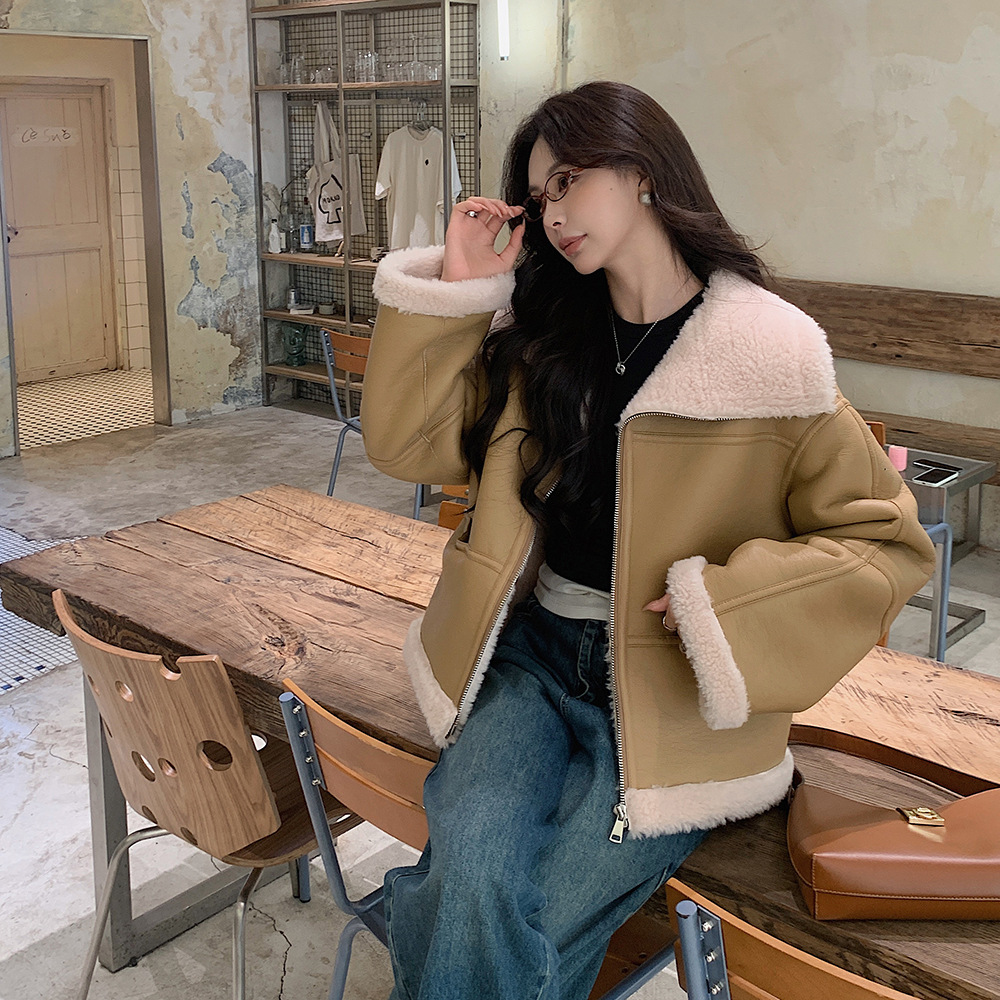 Woman in cozy jacket at rustic cafe.