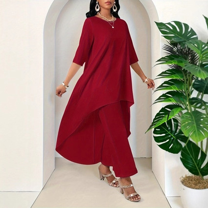 Woman in red outfit near plants.