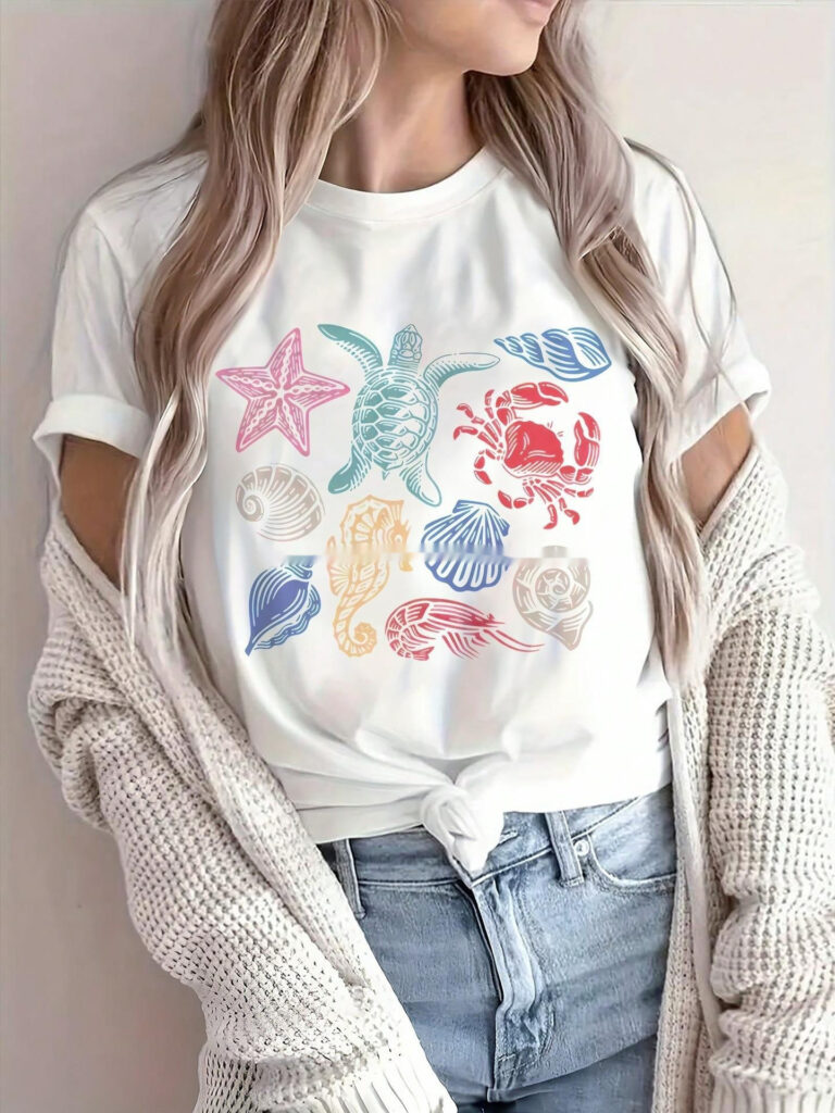 Woman wearing sea-themed graphic t-shirt.