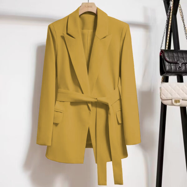 Yellow blazer with belt on hanger.