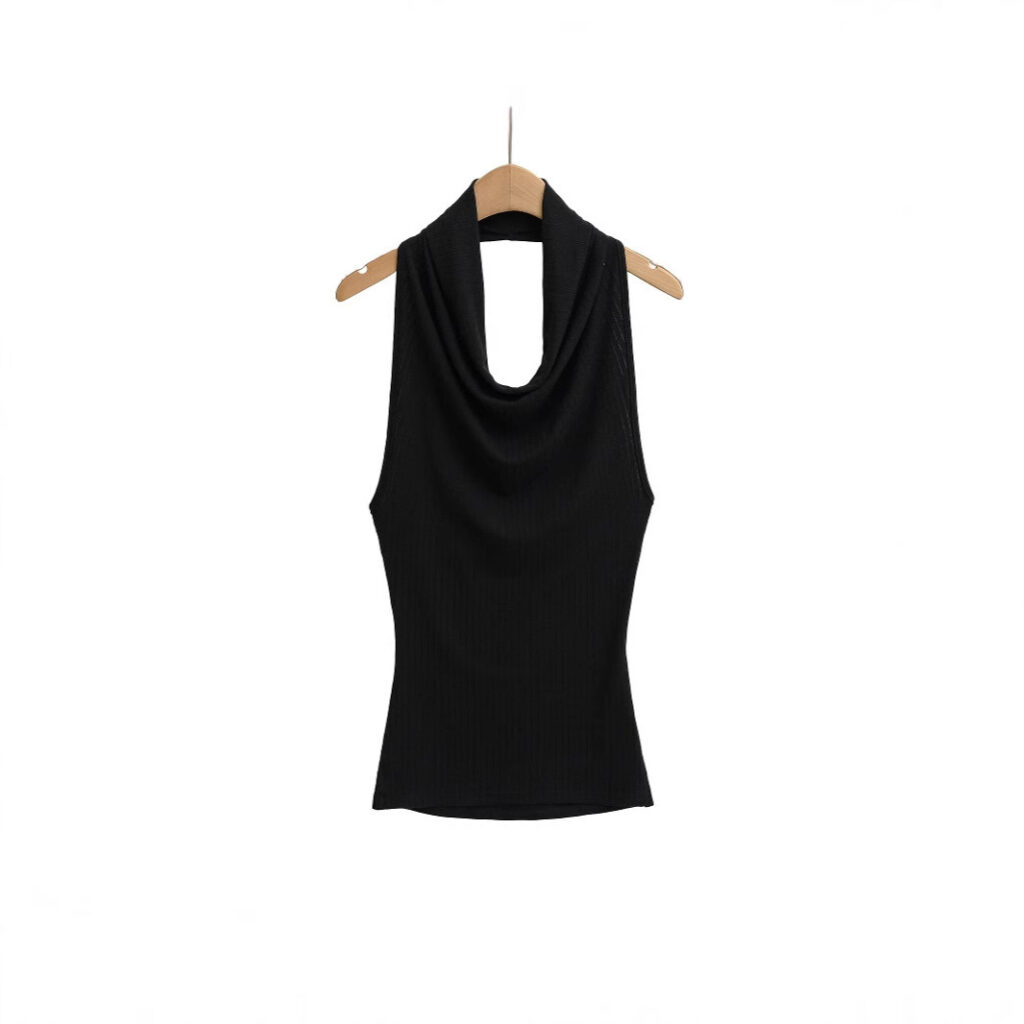 Black sleeveless top hanging on hanger.