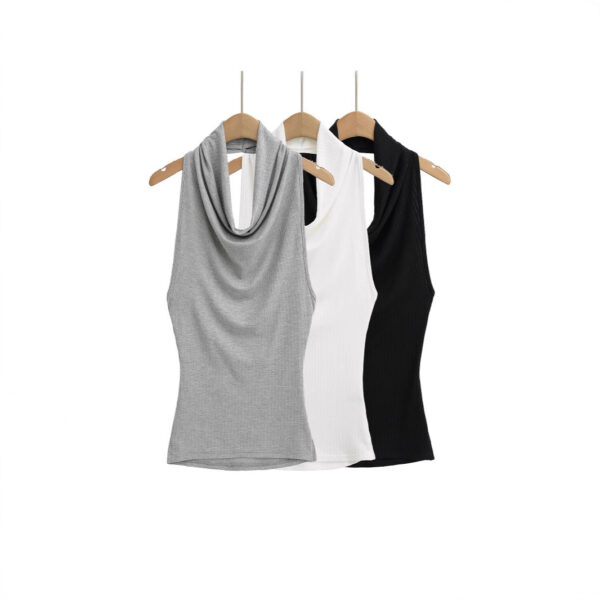 Three sleeveless tops on wooden hangers.