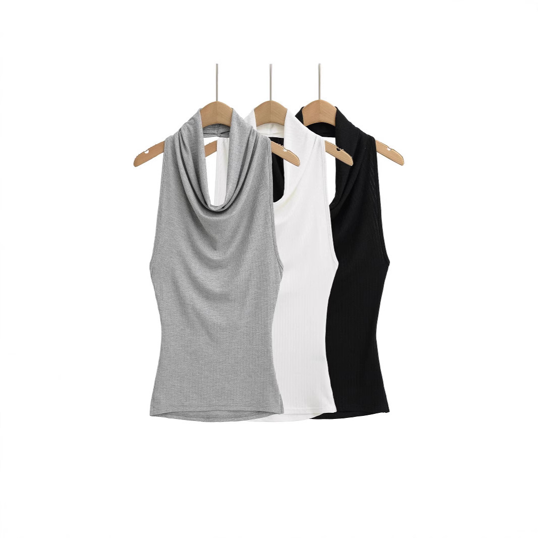 Three sleeveless tops on wooden hangers.