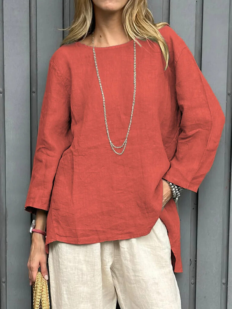 Woman in red tunic and white pants.