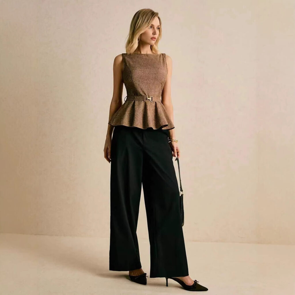 Woman in stylish outfit posing gracefully.