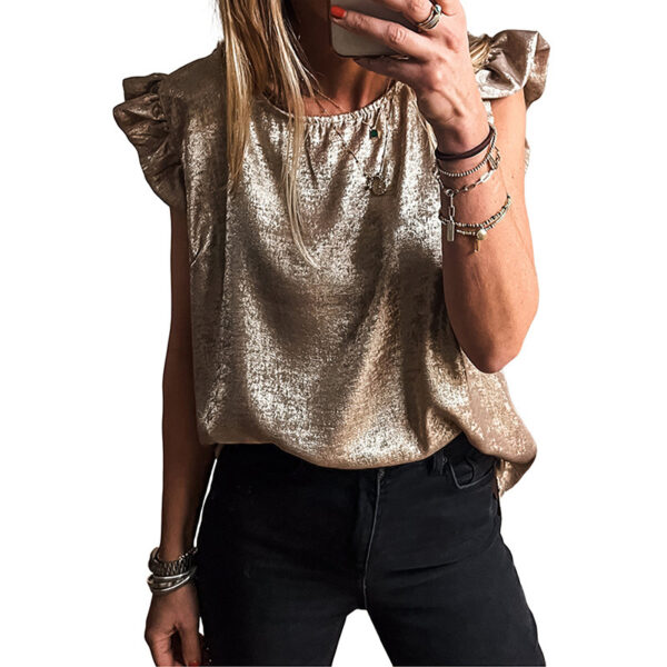 Woman in metallic top taking selfie.