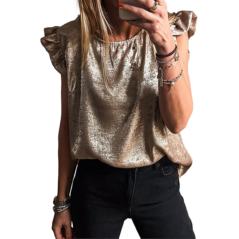 Woman in metallic top taking selfie.