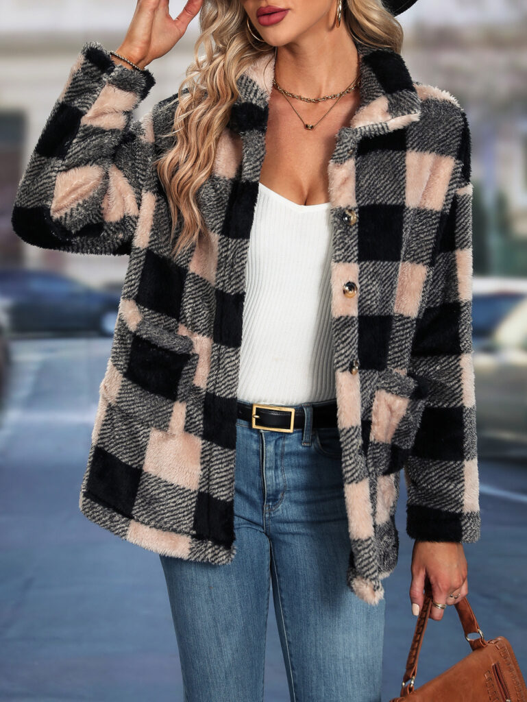 Woman wearing plaid coat and jeans.