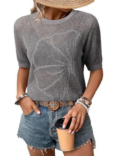 Woman in gray sweater holding coffee cup.