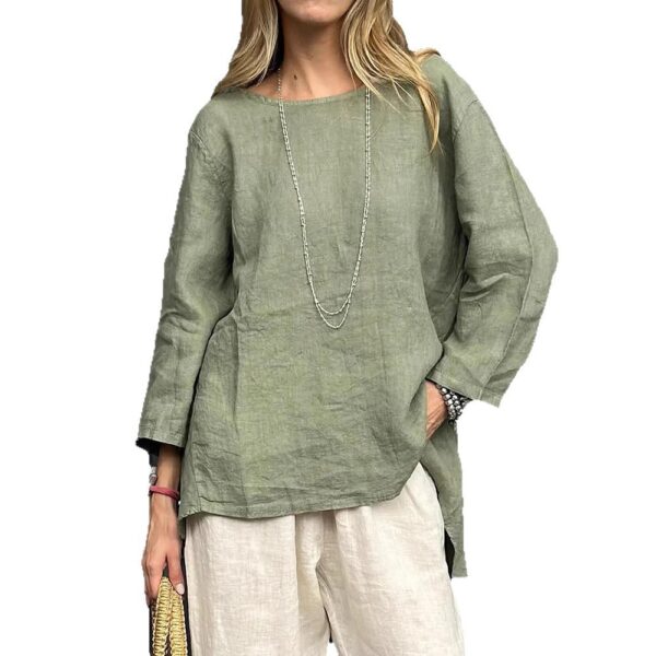 Woman in green top and white pants.