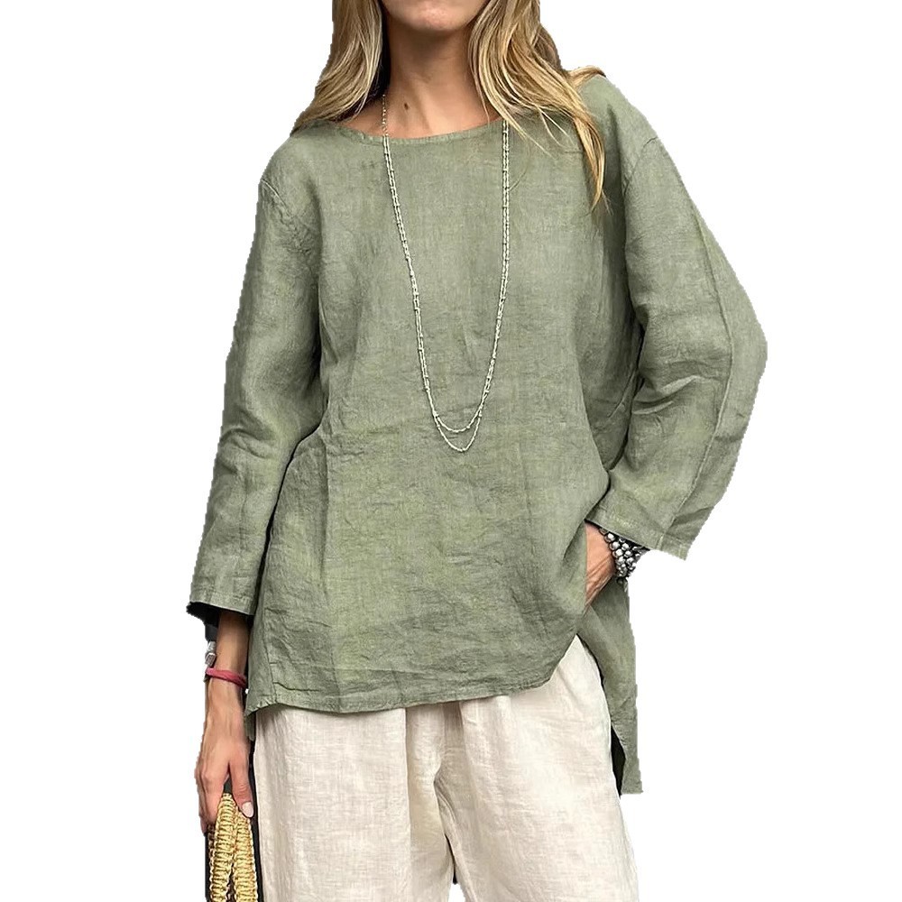 Woman in green top and white pants.