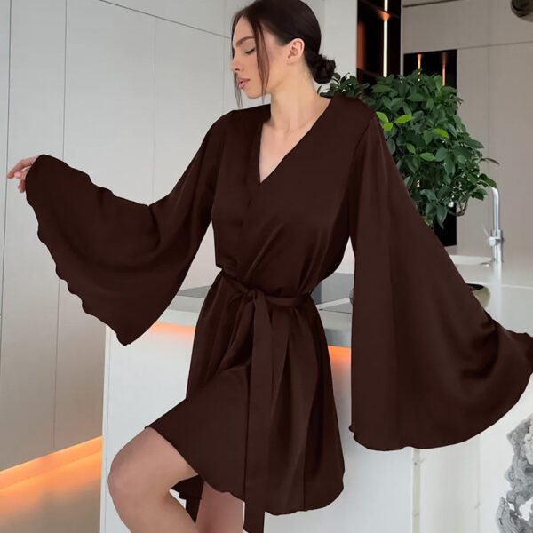 Woman in brown dress with flared sleeves.