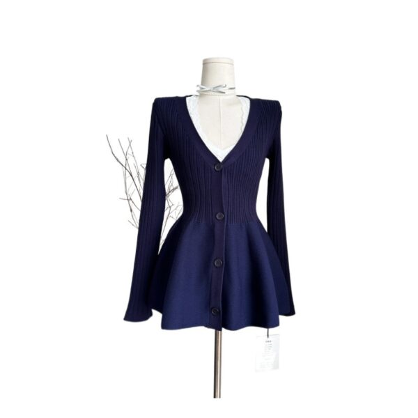 Navy blue flared cardigan on mannequin.