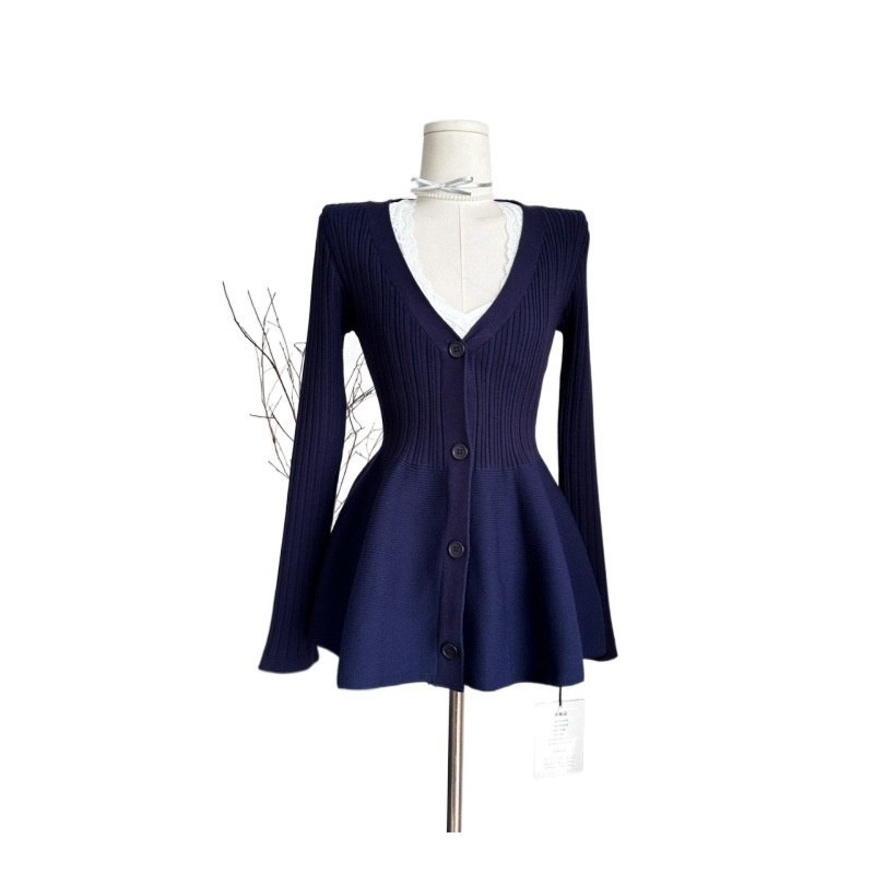 Navy blue flared cardigan on mannequin.