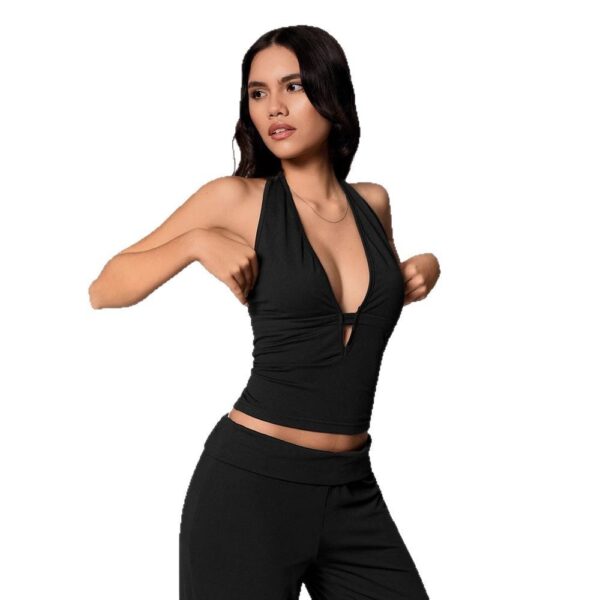 Woman posing in stylish black outfit.