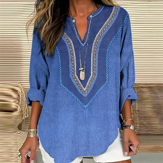 Woman wearing blue tunic and white shorts.