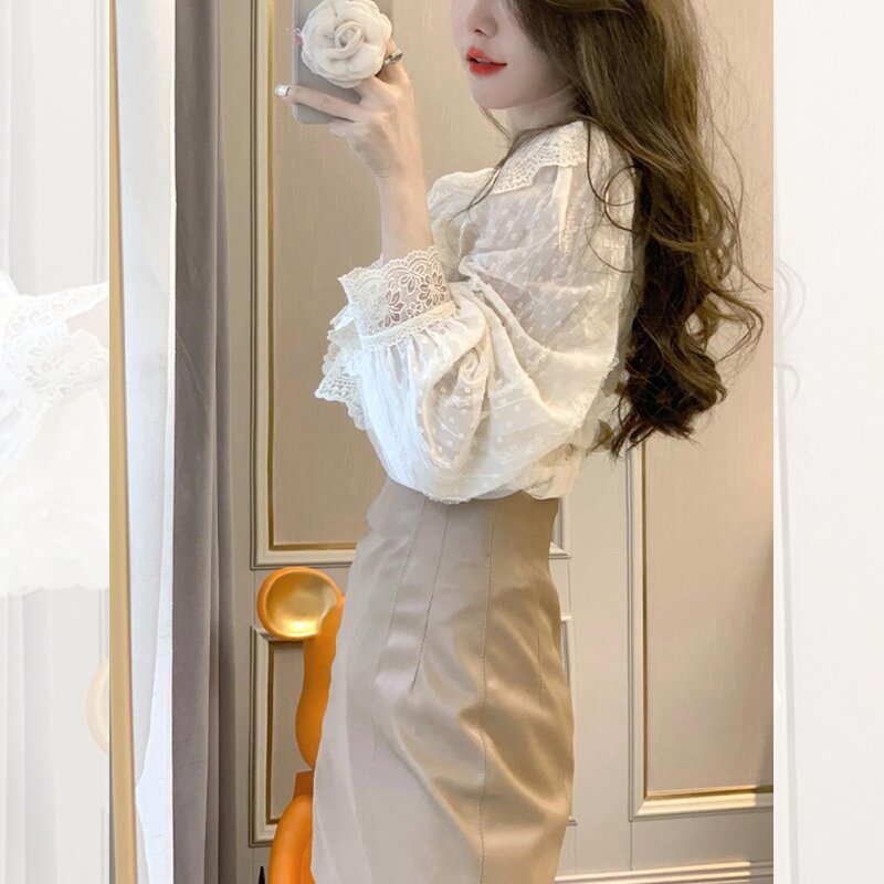 Woman posing in elegant outfit indoors.