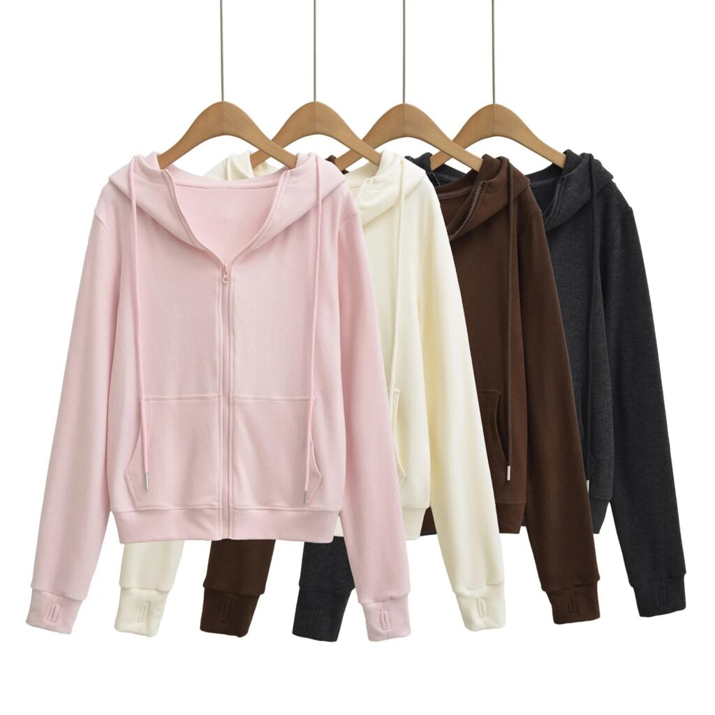Five hoodies in different colors on hangers.