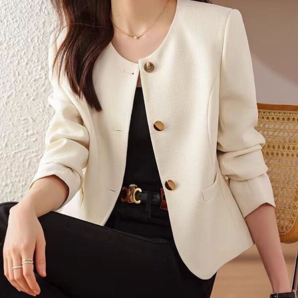 Woman in white blazer, black outfit.