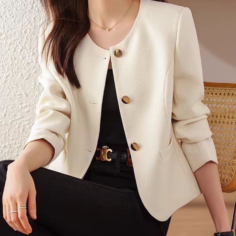Woman in white blazer, black outfit.