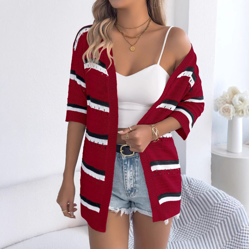Woman in red cardigan, white top, shorts.
