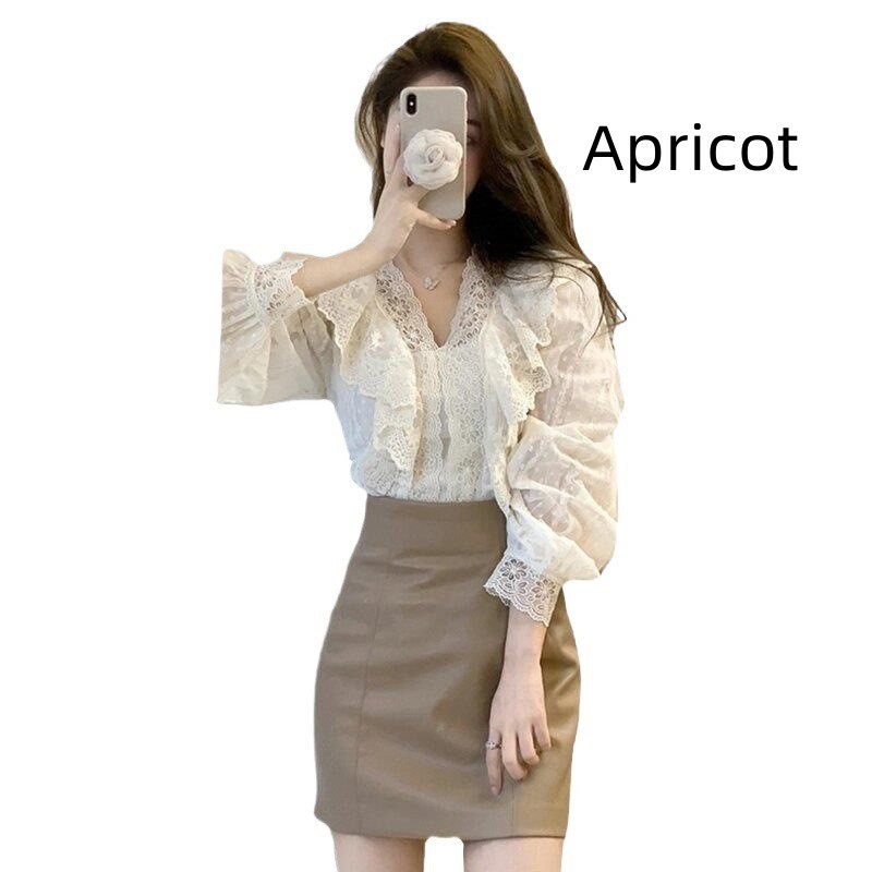 Woman in lace blouse and beige skirt.
