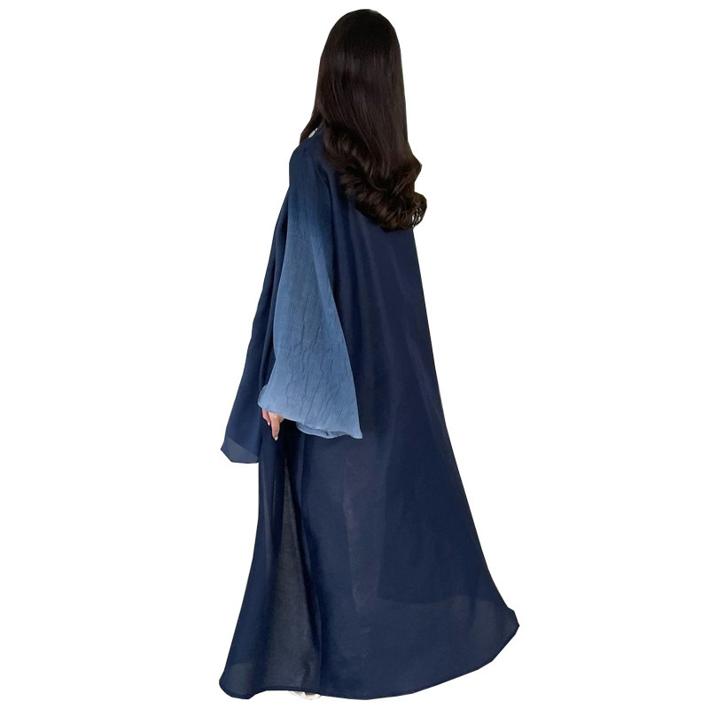 Woman in flowing blue robe, back view.