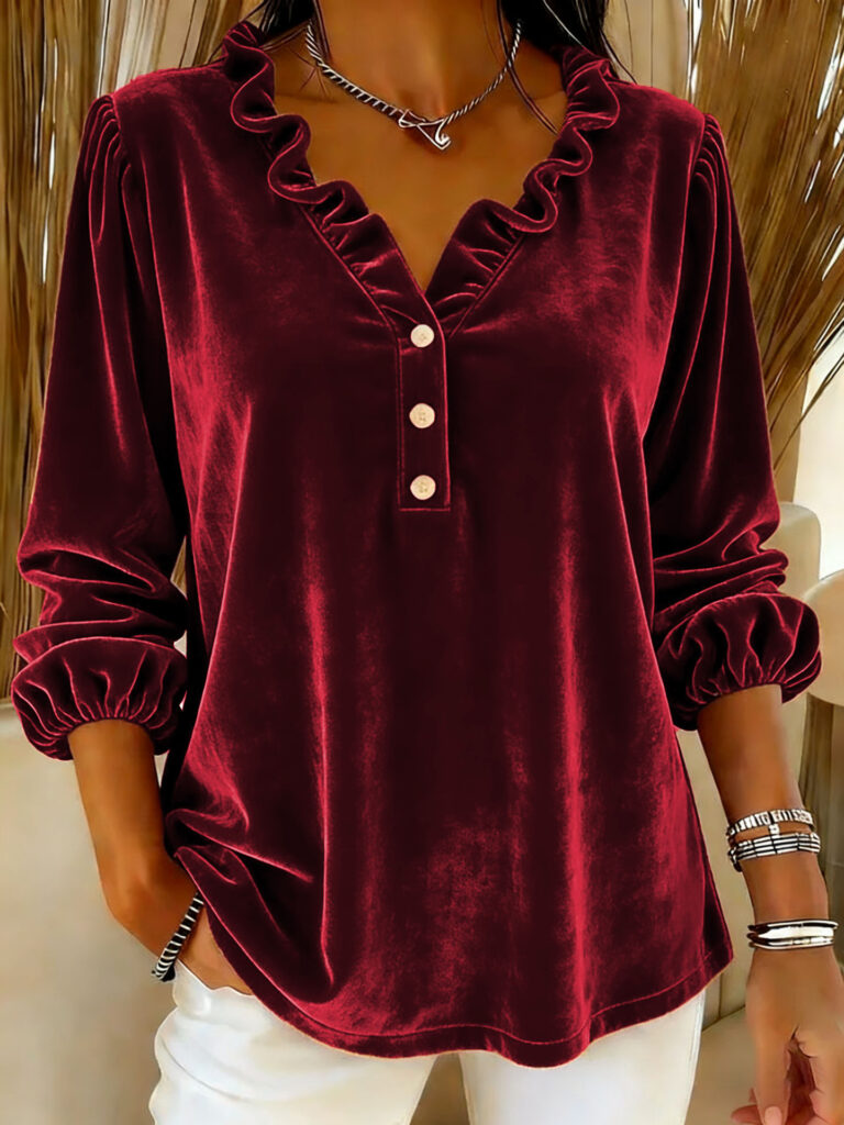 Red velvet blouse with ruffled neckline.
