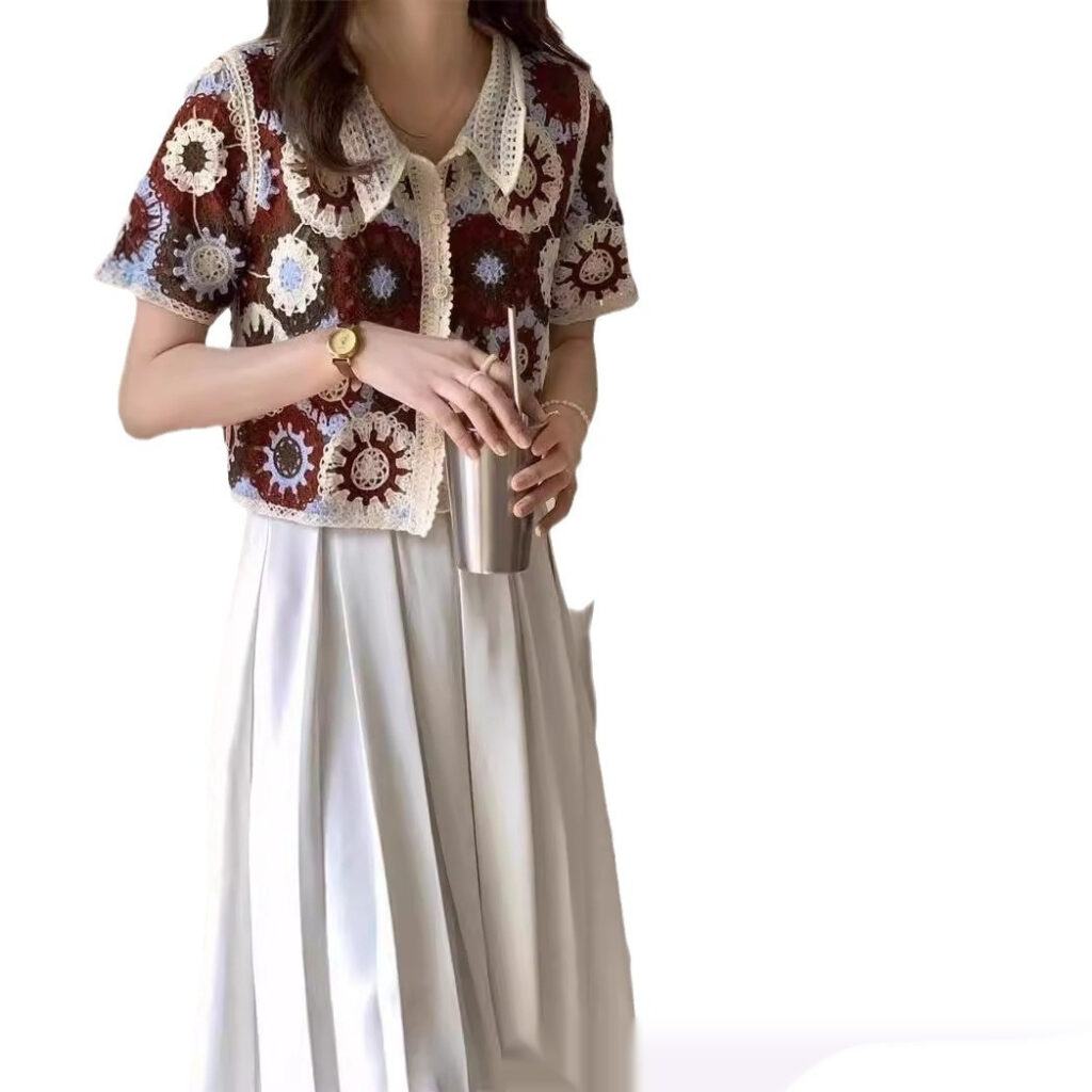 Woman in crochet top with drink.