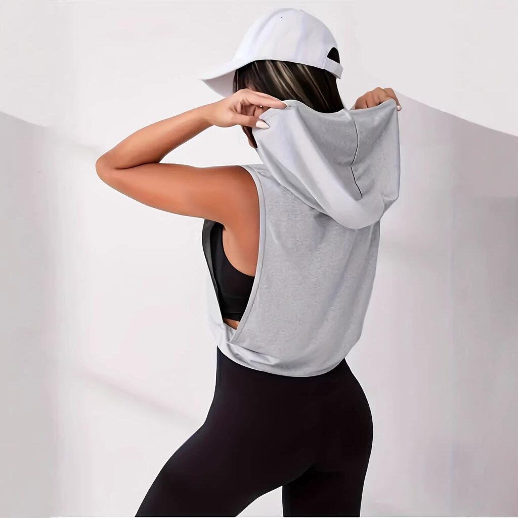 Woman in athletic wear adjusting cap.