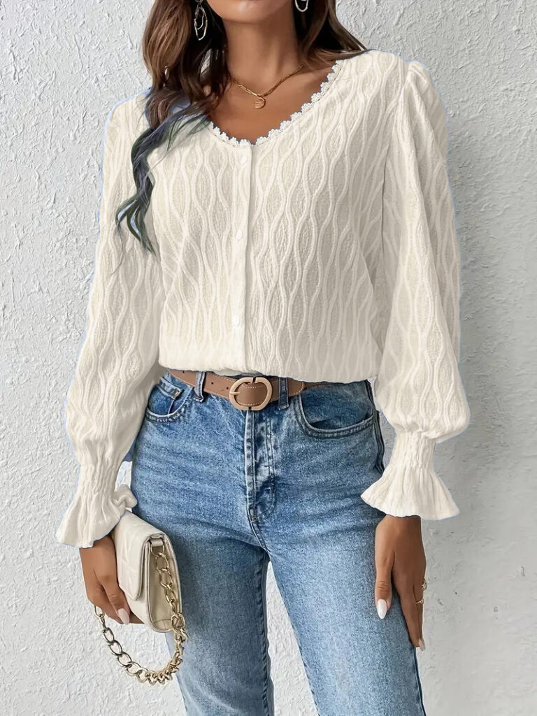 White sweater with jeans and beige purse.