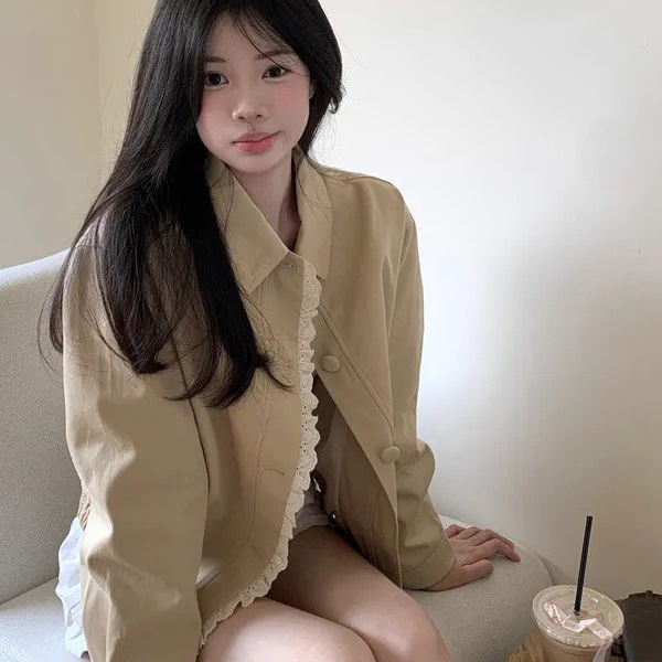 Young woman sitting with a drink.
