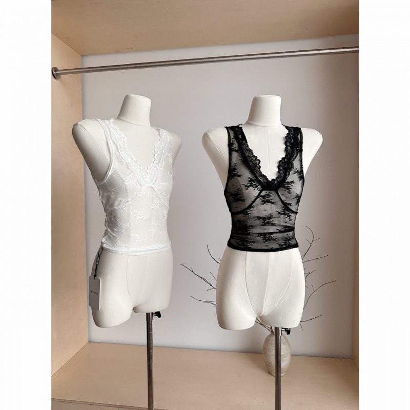 White and black lace tops on mannequins.