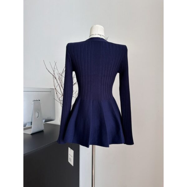 Navy ribbed sweater on mannequin.
